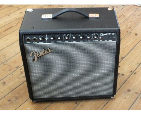 A boxed Fender Champion 40 amplifier plus a Fender Mustang two button foot switch, with owners manual and receipt of purchase