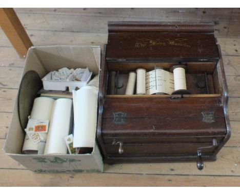 An oak cased fairy musician paper roll hand cranked music player plus a mechanical music paper rolls, cigarette and trade car