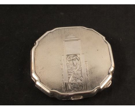 A lady's silver compact with engine turned decoration