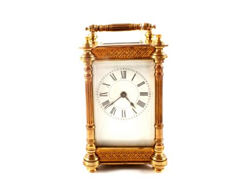 A carriage clock in ornate brass case (cracked dial)