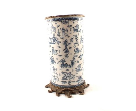 A blue and white metal mounted stick stand with multiple figure and animal decoration