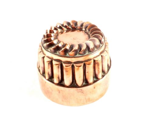 A large Victorian circular copper jelly mould with fluted surround and the top with circle of overlapping discs, stamped '250
