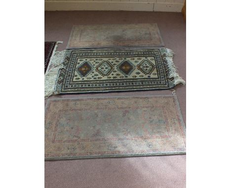 A Persian rug plus two wool mats