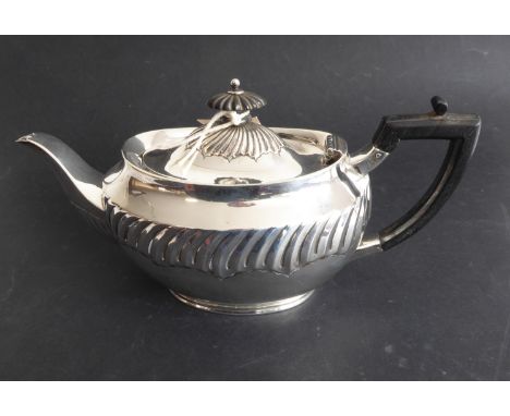 A three-piece hallmarked silver bachelor's style tea service comprising teapot, two-handled sugar and cream jug; the sugar an