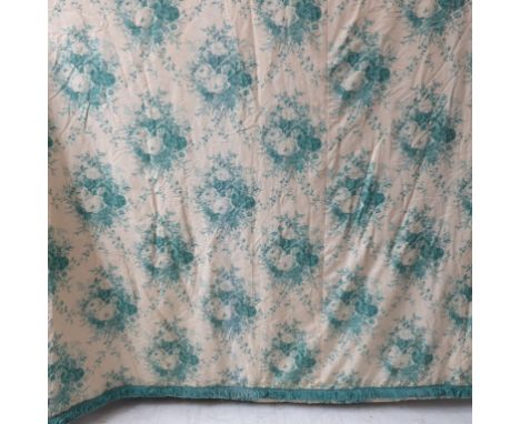 A pair of curtains in a cream and green patterned silk effect damask with a green floral print, thick green fringed edging, g