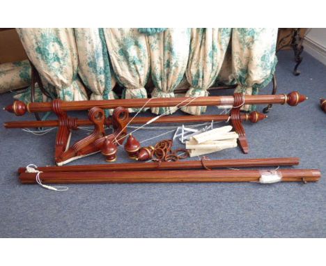 A pair of double curtain poles; the poles made of fluted stained oak with gilded details and decorative finials, with fluted 