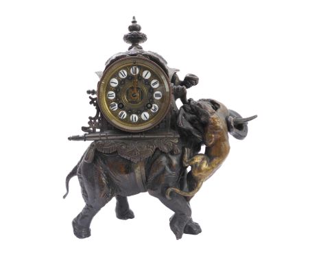 An unusual 19th century eight-day spelter-cased mantle clock modelled as a big cat attacking an elephant: the 9.75cm diameter