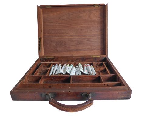 An early 20th century mahogany artist's travelling paint-box. The hinged lid with brass adjustable stay with a hinged front e