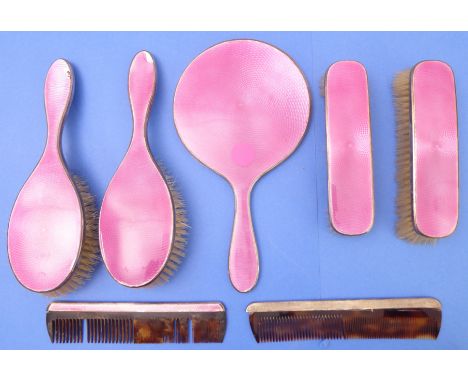 A lady's six-piece hallmarked silver and pink guilloché enamel dressing-table set comprising hand-held mirror, a pair of clot