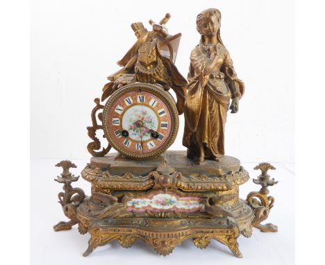 A late 19th century French gilt-metal figural mantle clock for restoration: porcelain dial with light-pink chapter ring and w