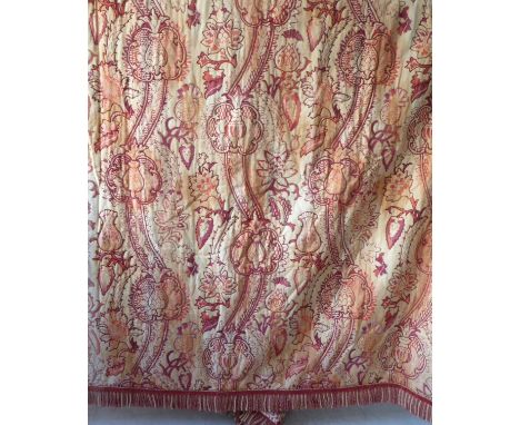 A pair of cream linen type curtains richly patterned with a mulberry and terracotta design edged with a velvet and cord fring