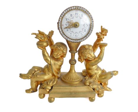 An early to mid 19th century&nbsp;small and heavy French ormolu figural mantle clock: the white enamel dial with Arabic numer