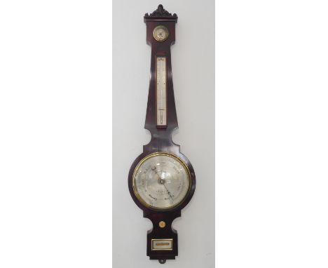 A mid-19th century mahogany-cased wheel barometer: the foliate carved pediment with scroll-ends above a DRY-DAMP dial, the th