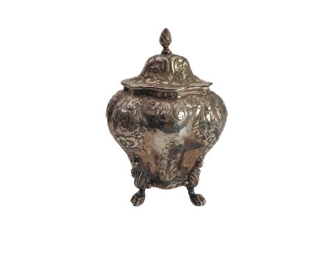 A hallmarked silver tea caddy of Bombé form: the hinged dome-topped lid with a spiral finial above a lobed body decorated rep