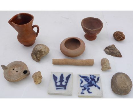 A selection of mostly early pottery and associated etc. to include a Roman terracotta oil lamp, a shaped and honed Stone Age 