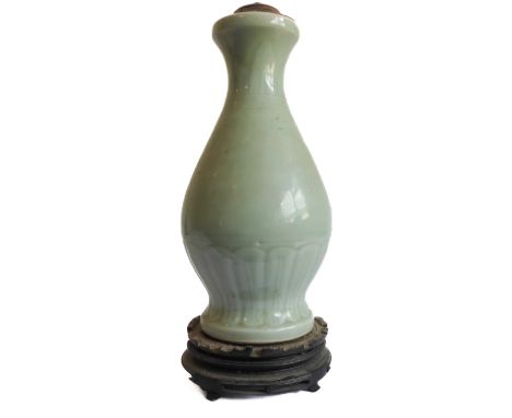 A Chinese celadon glaze porcelain vase of baluster form (now as a lamp) and on carved base (base broken): the waisted neck wi