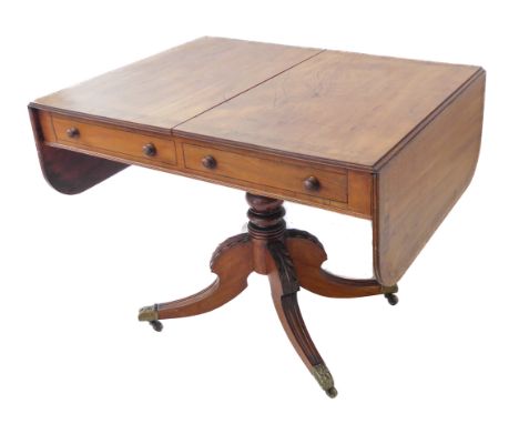 An early 19th century George IV period mahogany and rosewood crossbanded sofa table: two half-width drawers and two dummy dra