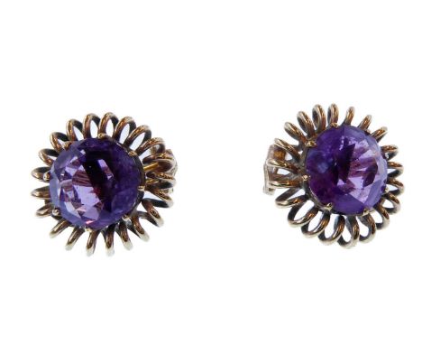 A pair of amethyst and wirework ear clips, each circular faceted amethyst coronet-set above the wirework spiral border, each 