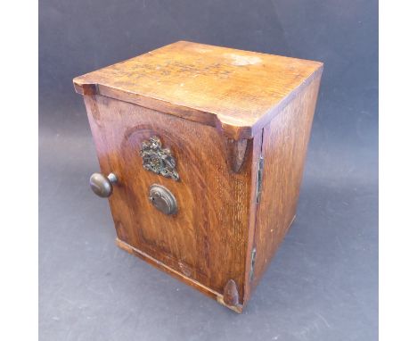 A 19th century novelty oak table safe: the hinged door with applied Royal crest above a 'Secure' lock and opening to reveal t