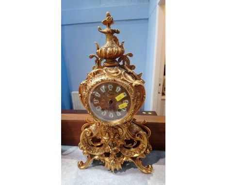 A brass Urgos mantle clock
