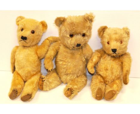 Three Post-War Chiltern Teddy Bears, glass eyes, one with velvet pads and two with oil cloth pads, with moth activity, (40cm)