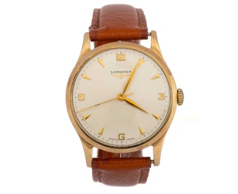 LONGINES, NINE CARAT GOLD MANUAL WIND WRIST WATCH, the round dial with Arabic and wedge hour markers, 33mm case, on a burnt o