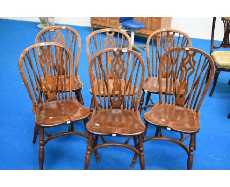 A set of six traditional stick back kitchen chairs having crinoline stretchers