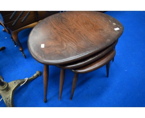 A vintage dark stained Ercol pebble style nest of tables