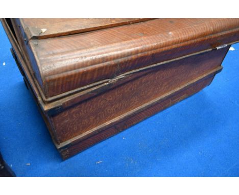 A vintage tin travel trunk having scumble effect finish