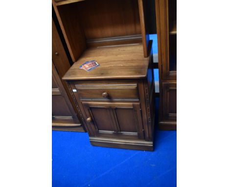 A modern Ercol mid stain narrow shelf with cupboard under