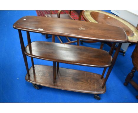 A dark stained Ercol trolley/bookcase, on replacement castors