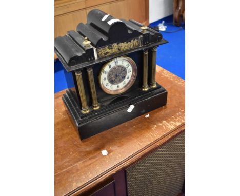 A Victorian black slate mantel clock