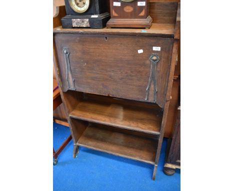 An Art Nouveau oak slim bureau with shelf under