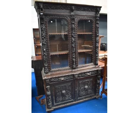 An 18th Century oak bookcase having carved and applique decoration with lion mask and green man , etc, on cupboard base
dimem