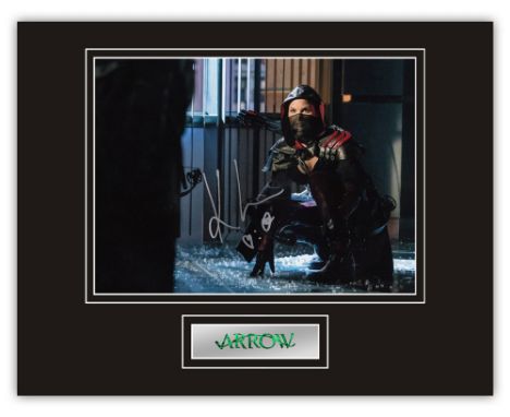 Stunning Display! Arrow Katrina Law hand signed professionally mounted display. This beautiful display consists of a 10"x8" p