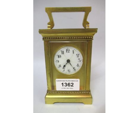 20th Century gilt brass cased carriage clock, the circular enamel dial with Arabic numerals (hairline cracks), with key, 12.5
