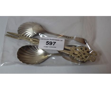 Three various silver caddy spoons and two pickle forks 