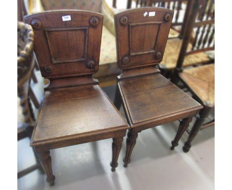 Pair of 19th Century oak hall chairs, having turned tapering front supports, together with an ebonised low seat nursing chair