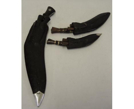 Wilkinson Sword Company kukri and scabbard, the blade inscribed W. S. C. 51, together with two other smaller kukrissee additi
