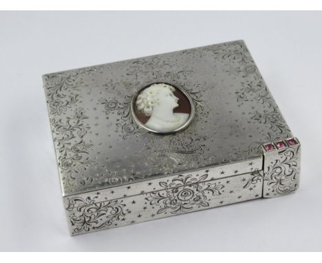Continental silver compact with integral lipstick, the hinged cover inset with an oval shell cameo portrait and all over flor