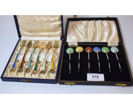 Boxed set of six white metal bean handled coffee spoons with enamelled backs together with a boxed set of Danish silver forks