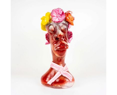 Tall handmade art glass vase modeled as a head with neck scarf and flowers around top. Multiple glass techniques demonstrated