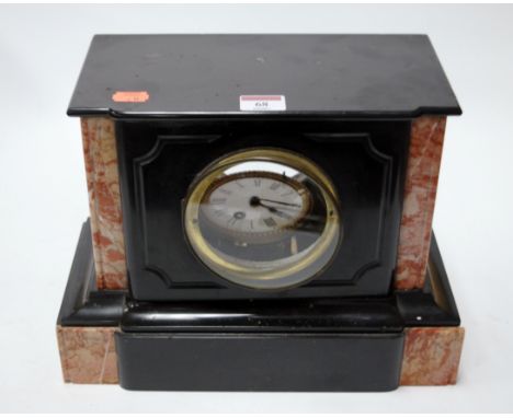 A late Victorian black slate and rouge marble cased mantel clock having an enamel dial with Roman numerals, width 32cm