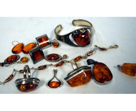 A collection of assorted amber, silver and white metal set ladies jewellery to include a bangle, dress rings, pendants etc