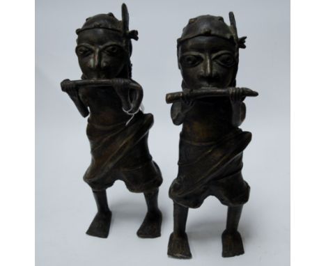 A pair of Benin(?) bronze figures, each in the form of a standing man blowing a horn, h.40cm 
