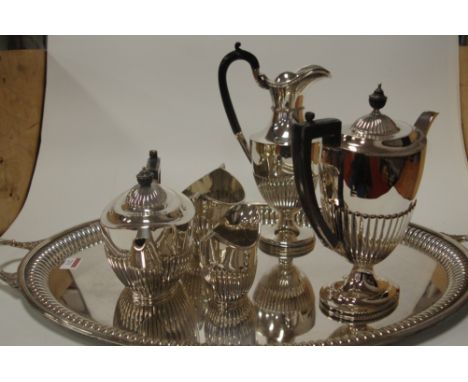 An early 20th century silver plated five piece tea and coffee service, of oval half-reeded form, by Mappin & Webb, on twin ha