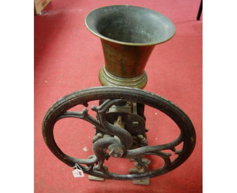 A large cast iron and brass coffee grinder with original handle