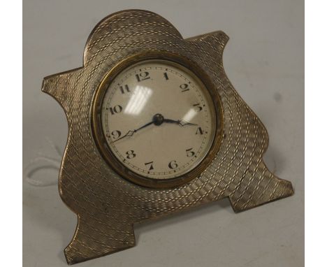 An Edwardian silver cased travel clock, having all-over engine turned decoration, probably by John Henry Wynn, Birmingham 190