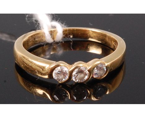 An 18ct gold and diamond three stone ring, total diamond weight estimated at 0.24ct, size K 