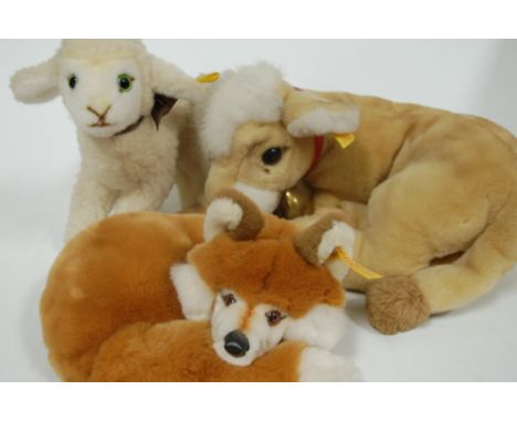 A modern Steiff soft toy in the form of a recumbent calf with bell, yellow label to ear together with two others, fox and lam